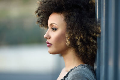 Close-up of thoughtful woman with curly hair