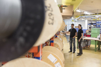 Two men standing in factory