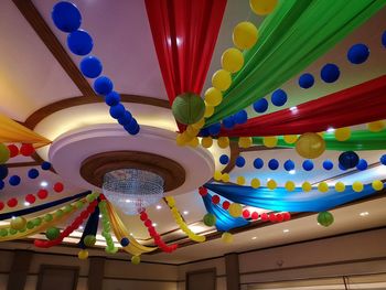 Low angle view of multi colored lanterns hanging from ceiling in building