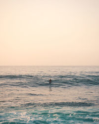 Scenic view of sea against clear sky during sunset