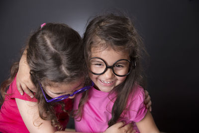 Smiling girls against black background