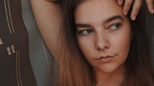 Close-up of thoughtful young woman looking away