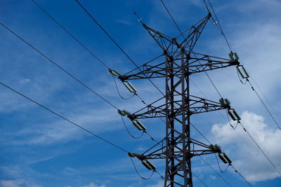 Low angle view of electricity pylon against sky