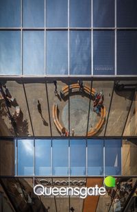 Low angle view of building seen through glass window