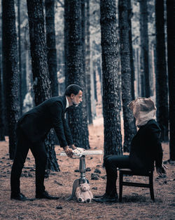 Rear view of man standing in forest