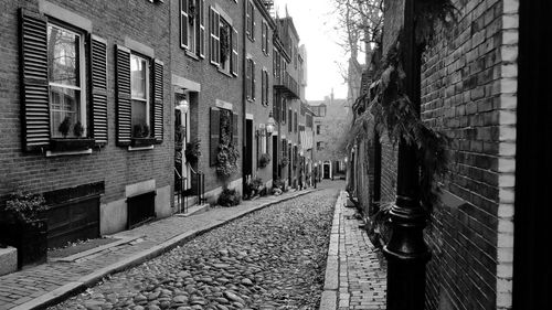 Narrow street amidst buildings in city