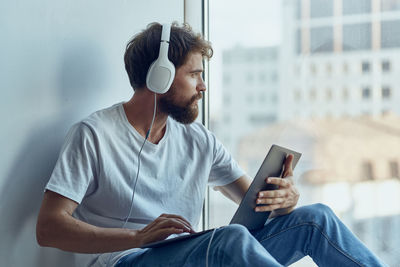 Midsection of man using mobile phone