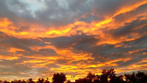 Low angle view of dramatic sky during sunset