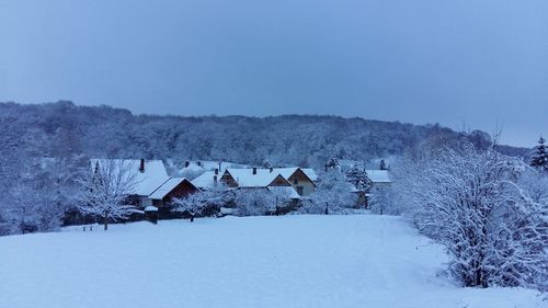 Scenic view of snow covered field against clear sky