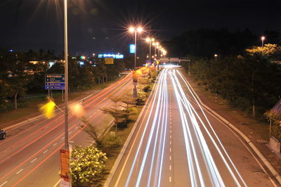 High angle view of light trails on road at night