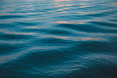 Full frame shot of waves in sea during sunset