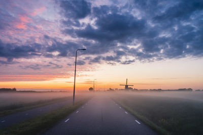 Street against sky during sunset