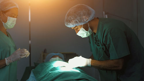Midsection of doctor examining patient at clinic