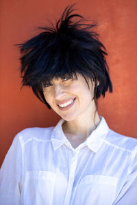 Woman with messy hairstyle isolated on red background