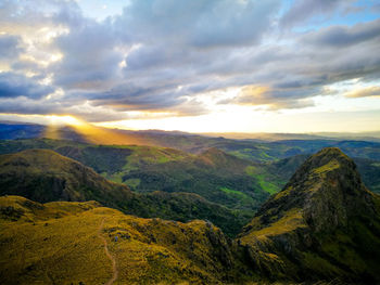 Scenic view of mountains against sky at sunset