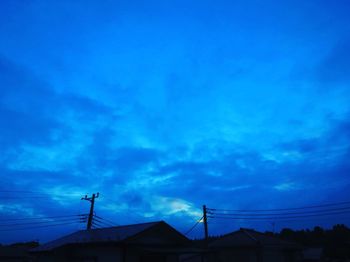 Low angle view of silhouette building against sky