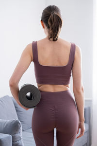 Rear view of woman exercising in gym