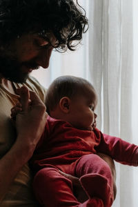 Midsection of mother and daughter at home