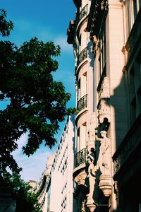 Low angle view of statue in city against sky