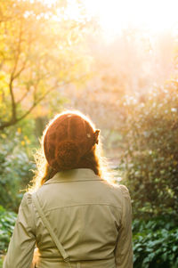 Rear view of boy against trees