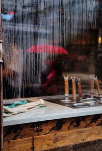 Wet table by window at night
