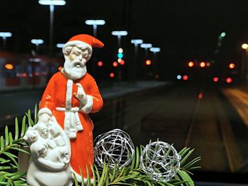Close-up of figurine sculpture on table at night