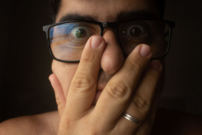 Close-up of human hand against black background