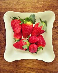 High angle view of strawberries in plate on table