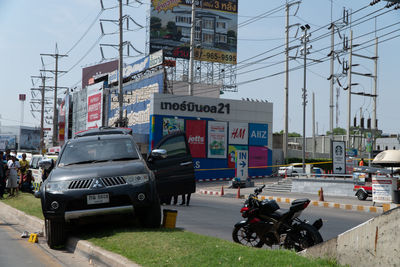 Vehicles on road against buildings in city