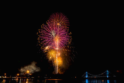 Low angle view of firework display in sky at night