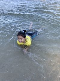 High angle view of girl lying on beach