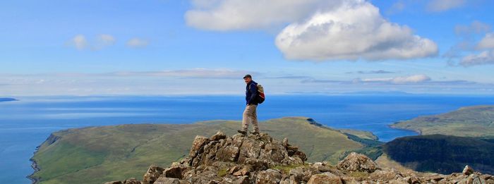 Man standing on mountain against sky