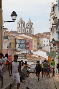 People on street amidst buildings in town