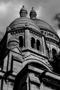 Low angle view of building against cloudy sky