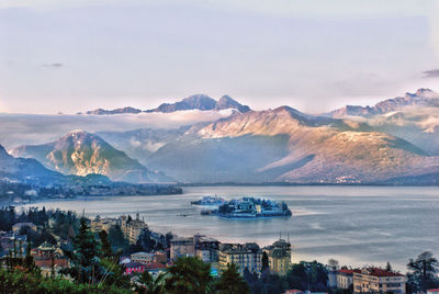 Scenic view of sea and mountains against sky