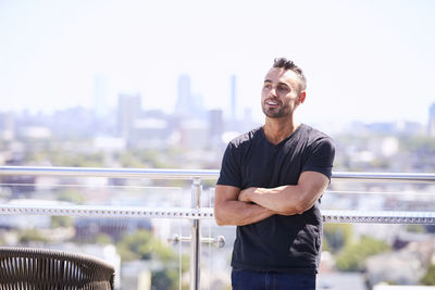 An outdoor portrait of a man with a city view.