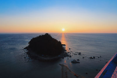 High angle view of sea against sky during sunset