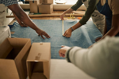 Midsection of business colleagues stacking hands