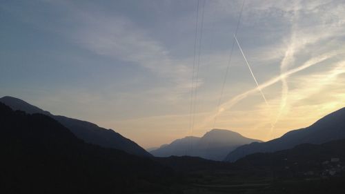 Scenic view of silhouette mountains against sky at sunset