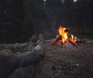 Low section of man with bonfire at night