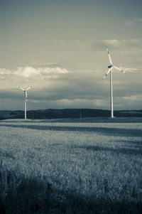 Windmill on field against sky