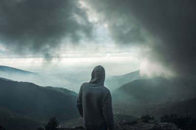 Man standing on mountain against sky at night