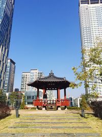 Low angle view of buildings against clear blue sky