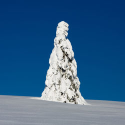 Low angle view of rock formations against clear blue sky