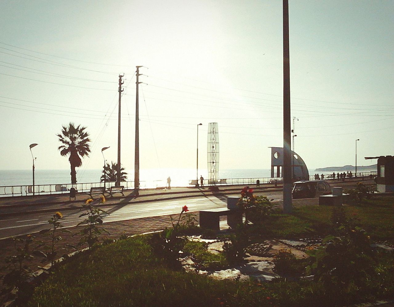 clear sky, beach, electricity pylon, sea, power line, water, sky, electricity, sand, shore, nature, transportation, tranquility, cable, day, fuel and power generation, outdoors, copy space, road, tranquil scene