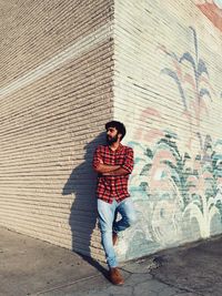 Full length of young man standing on wall