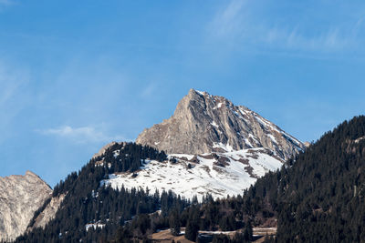 Panoramic view of snowcapped mountains against blue sky