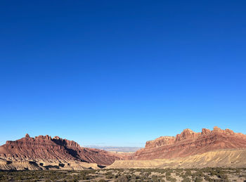 Scenic view of mountains against clear blue sky