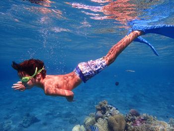 Close-up of boy swimming undersea