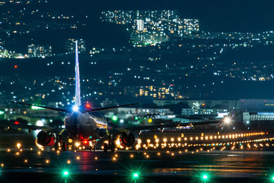 Rear view of airplane on runway at night